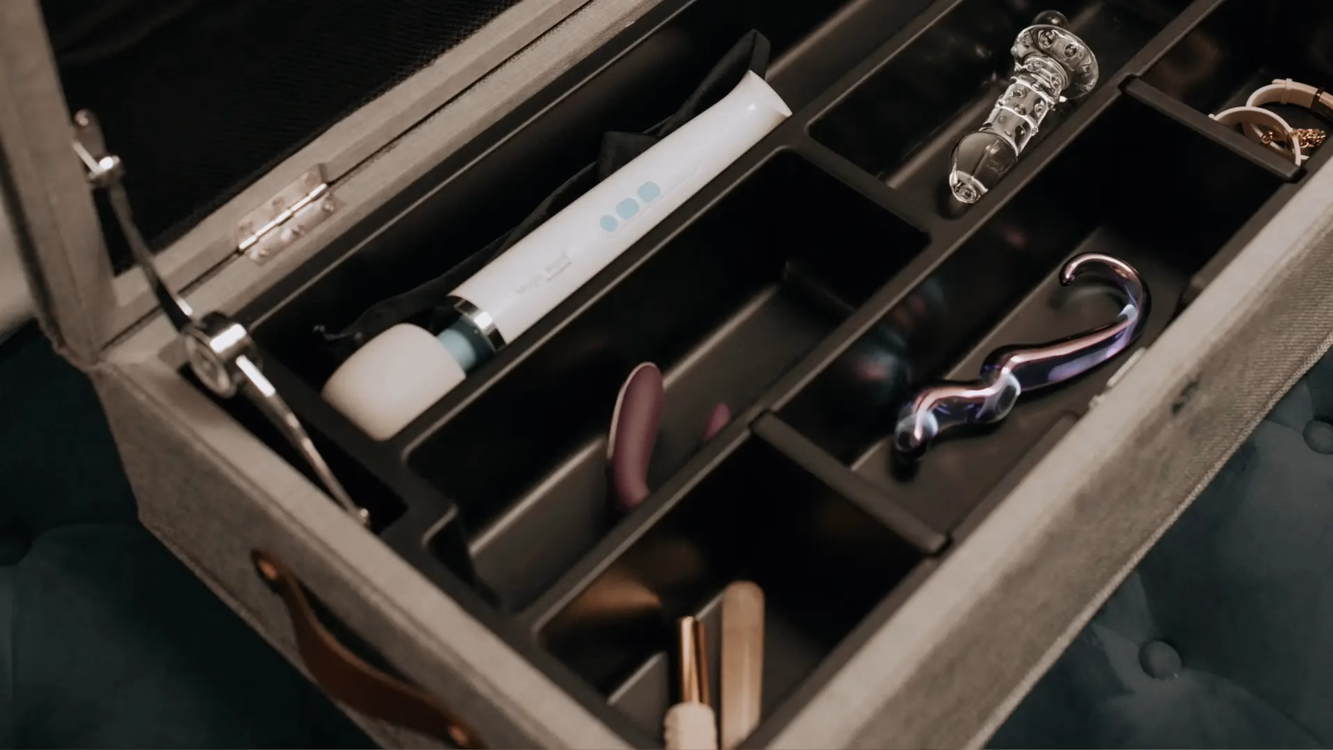 Interior of intimate locking storage box showing various sex toys